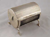 Appraisal: An unusual cylindrical silver dispenser for long smoker's matches with