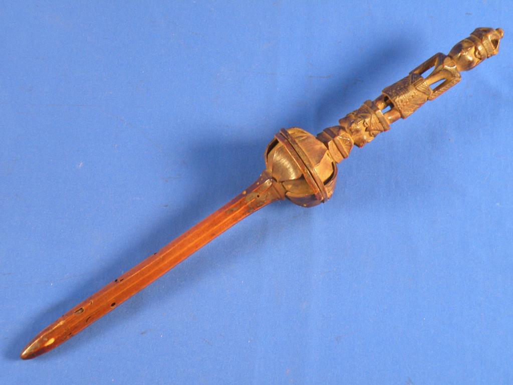 Appraisal: An African carved wood ceremonial rattle decorated in the form