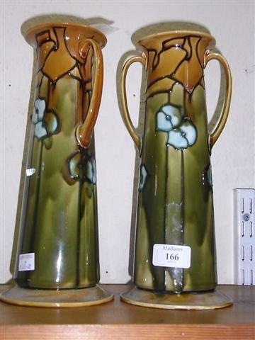 Appraisal: A PAIR OF MINTON MAJOLICA SECESSIONIST TAPERING TWO HANDLED VASES