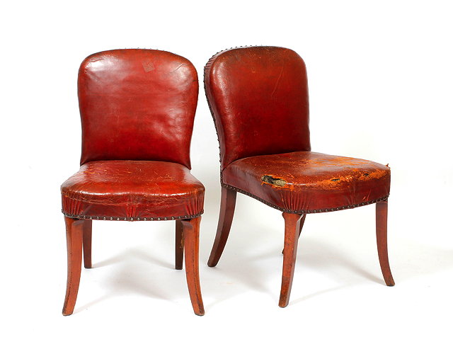 Appraisal: A PAIR OF ART DECO RED LEATHER UPHOLSTERED SIDE CHAIRS