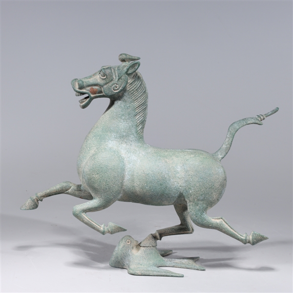 Appraisal: Chinese bronze model of a Han Dynasty galloping horse atop