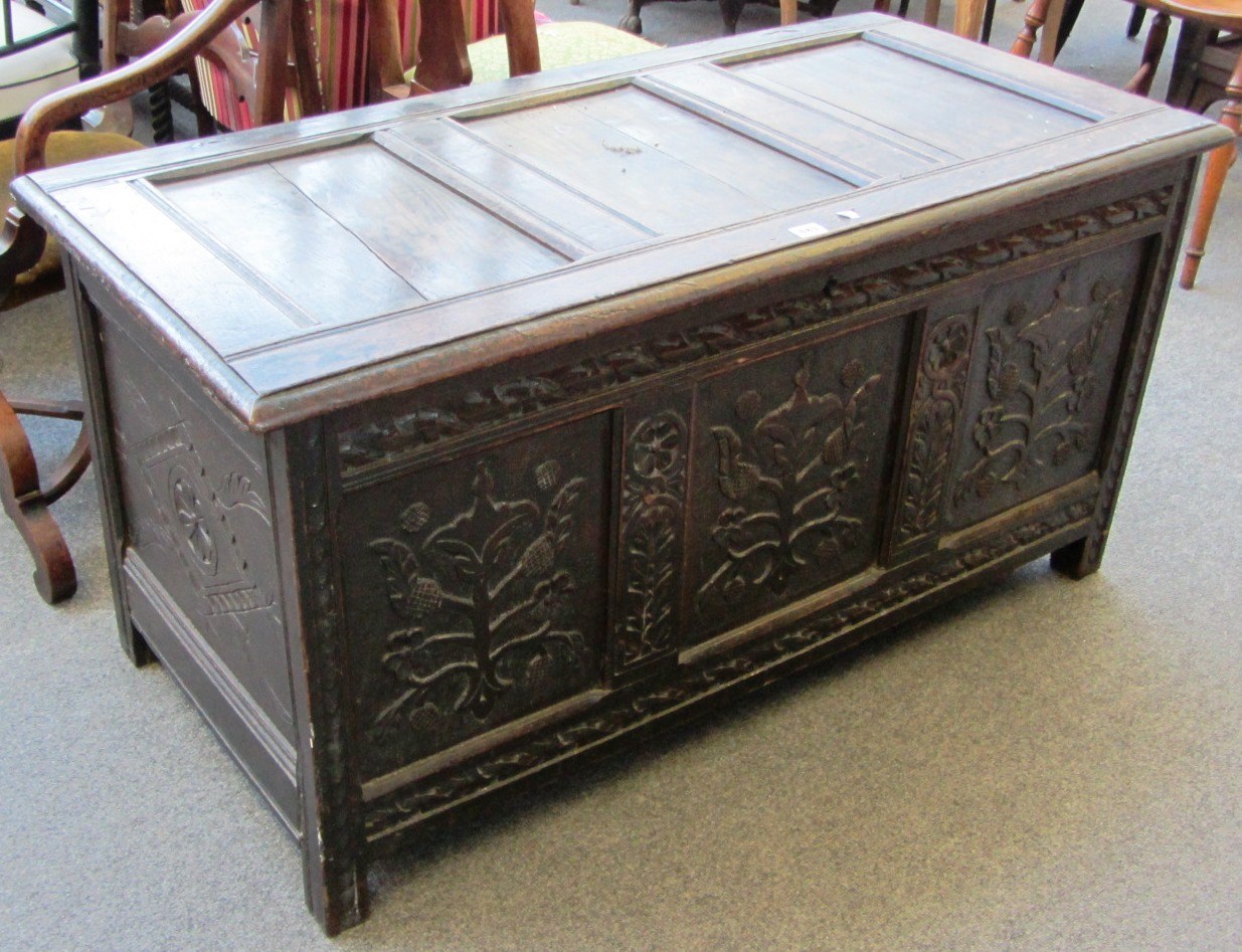 Appraisal: A Charles II oak coffer with carved triple panel front