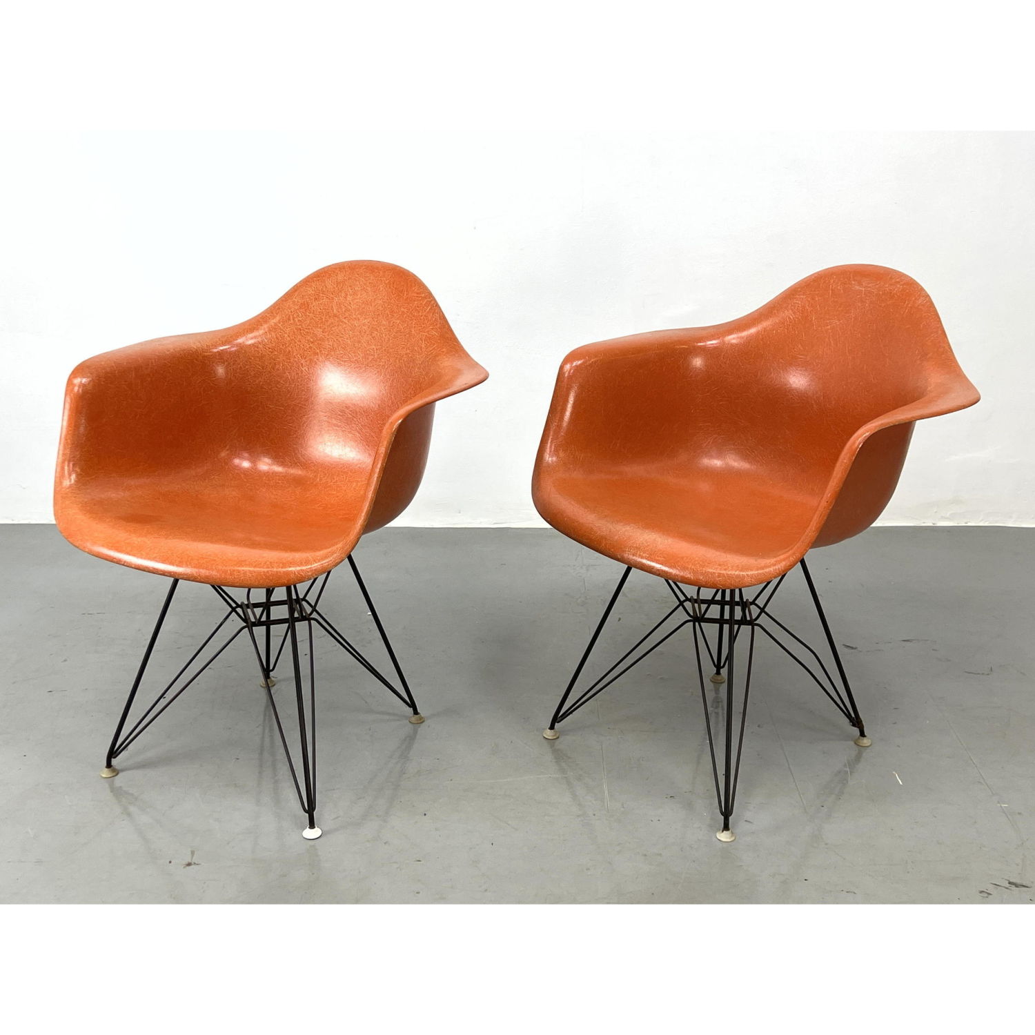 Appraisal: Pr Orange Fiberglass Eames arm chairs with Eiffel Tower bases