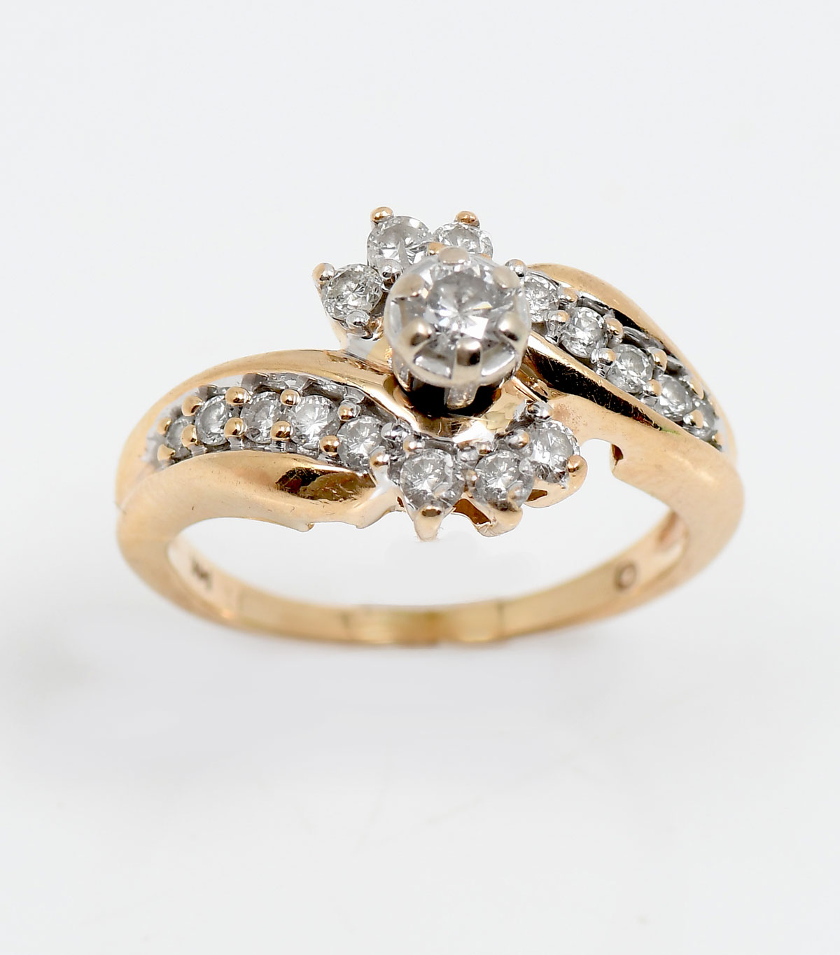 Appraisal: K DIAMOND RING Yellow gold bypass ring features a center