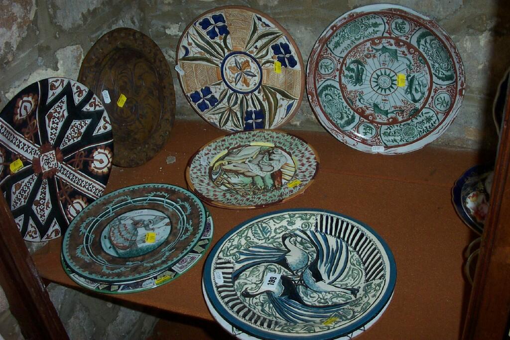 Appraisal: A collection of pottery plates with various hand painted decoration