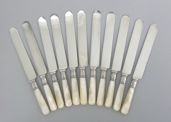 Appraisal: A Set of Mother-of-Pearl And Sterling Silver Handle Knives Containing