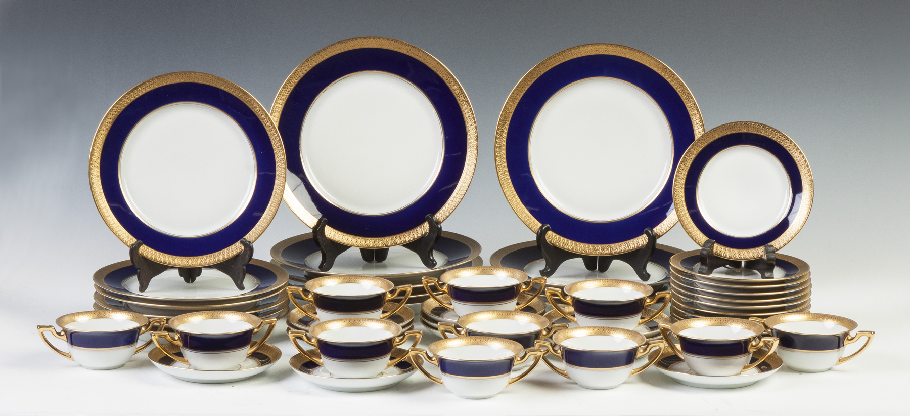 Appraisal: Bavarian Pembroke Porcelain Cobalt blue with relief gold decoration plates