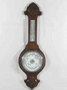 Appraisal: An aneroid wall barometer thermometer with ceramic dials in an