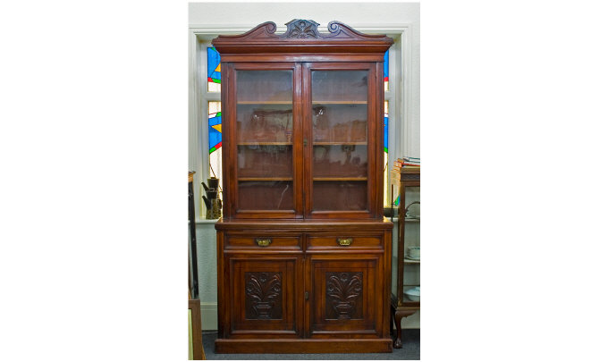 Appraisal: Late Victorian Mahogany Bookcase Carved Broken Pediment Above Glazed Doors