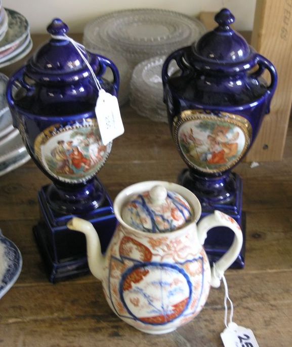 Appraisal: A pair of blue-ground porcelain urns printed with classical figures