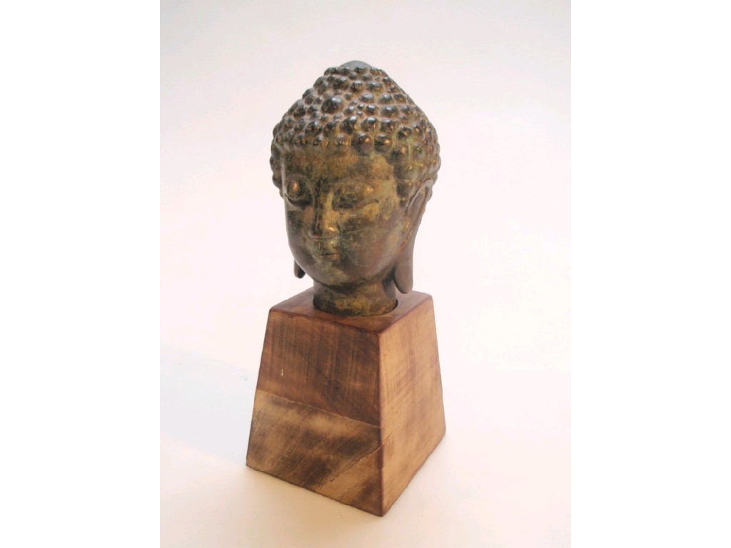 Appraisal: A modern bronze past and patinated bronze head of Buddha