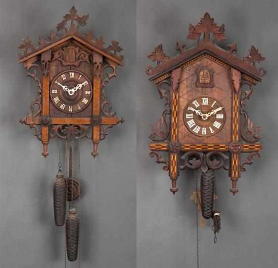 Appraisal: Two German Black Forest carved and parquetry inlaid wood cuckoo