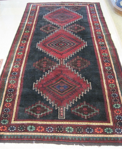 Appraisal: PERSIAN ILATI TRIBAL CARPET featuring three red diamond-shaped medallions on