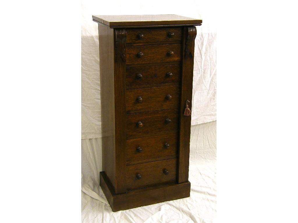 Appraisal: Small oak Wellington chest with seven graduated drawers to the