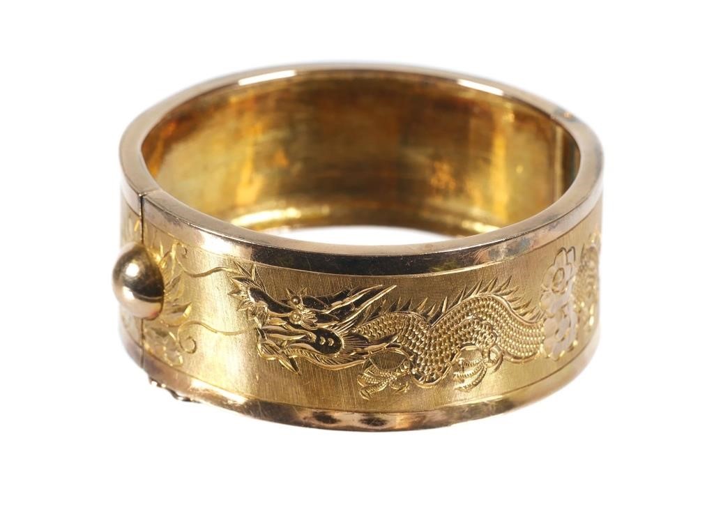 Appraisal: K yellow gold wide bangle bracelet featuring an engraved dragon