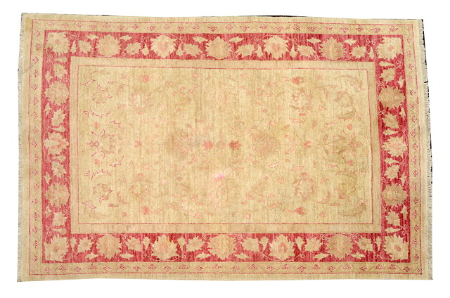 Appraisal: AN EASTERN RED GROUND SMALL CARPET with a central large