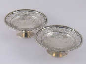 Appraisal: A pair of pierced silver bonbon dishes on spread foot