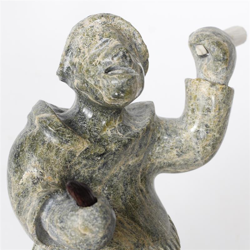 Appraisal: Inuit soapstone male hunter figure carving inch Inuit man holding