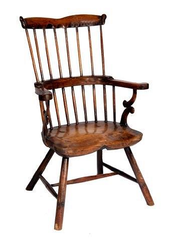 Appraisal: AN ANTIQUE PERHAPS WELSH ASH AND ELM COMB BACK ARMCHAIR