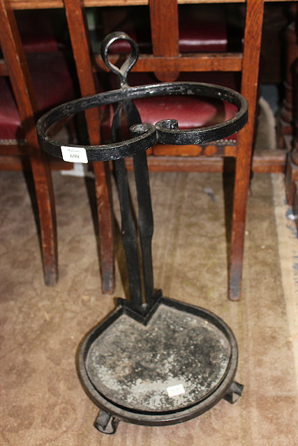 Appraisal: A BLACK PAINTED WROUGHT IRON STICK STAND standing on scroll