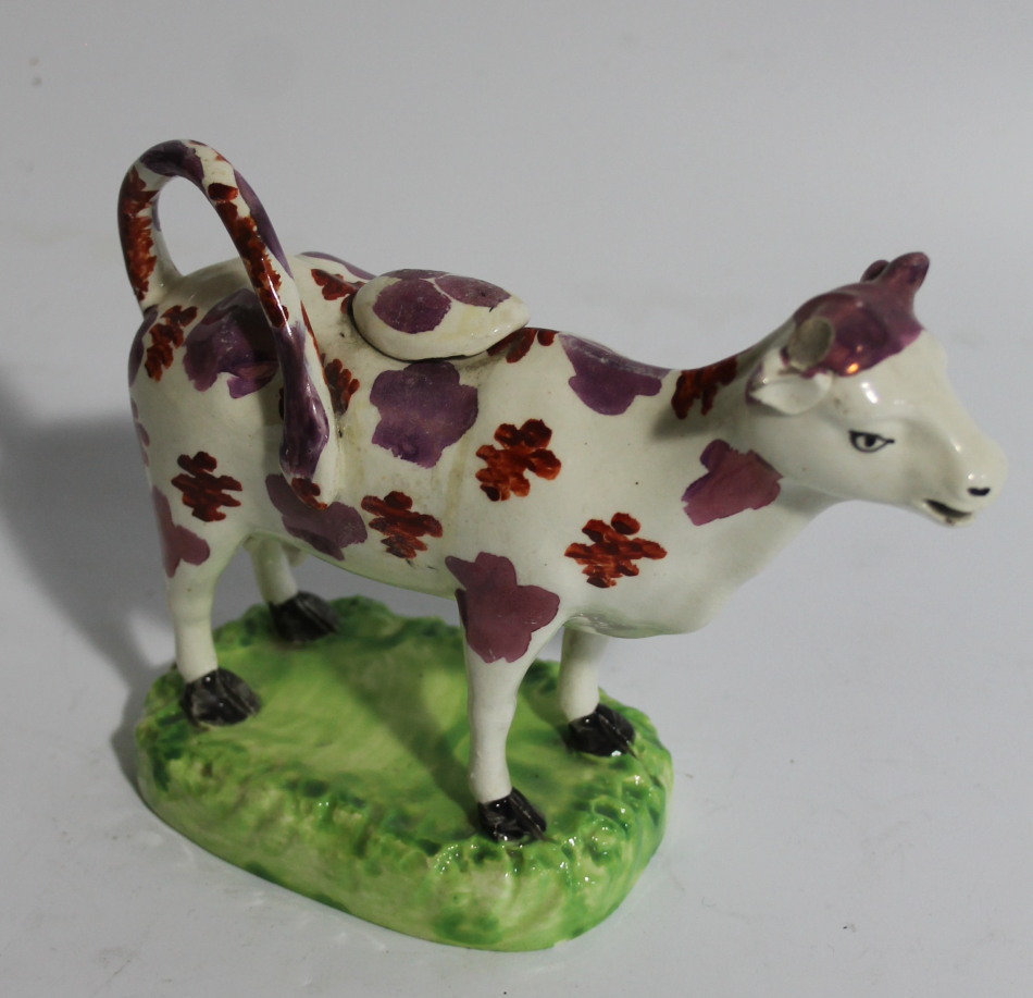 Appraisal: A mid- thC Staffordshire pink lustre cow creamer in standing