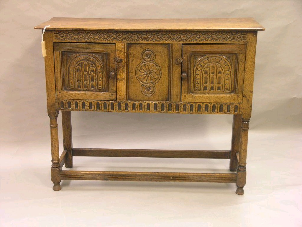 Appraisal: A Jacobean style solid medium oak side cupboard pair of