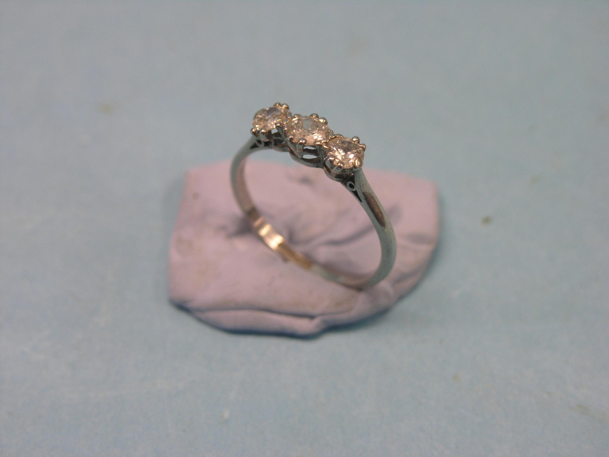 Appraisal: A platinum and three-stone diamond half-hoop ring central stone approx