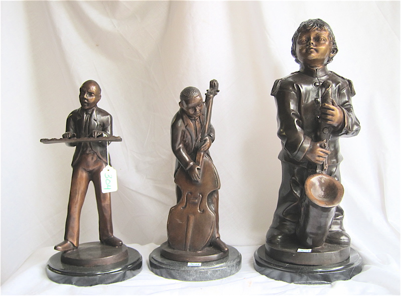 Appraisal: THREE PATINATED BRONZE MUSICIAN SCULPTURES all cast in standing poses