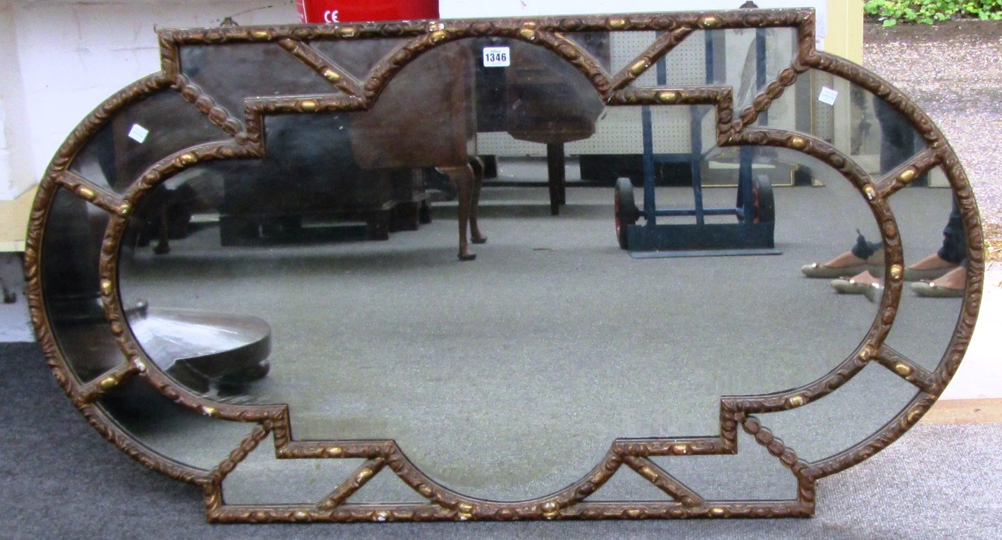 Appraisal: A th century gilt framed segmented wall mirror of rounded