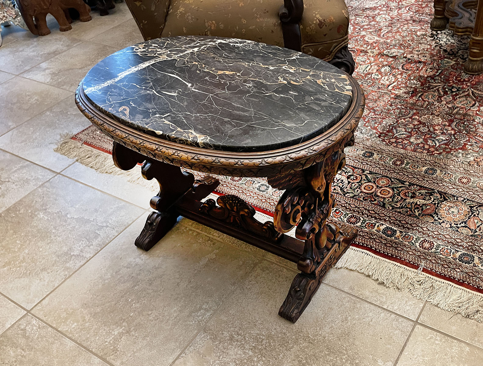 Appraisal: ITALIAN VARIEGATED MARBLE CARVED LOW TABLE Oval marble top resting