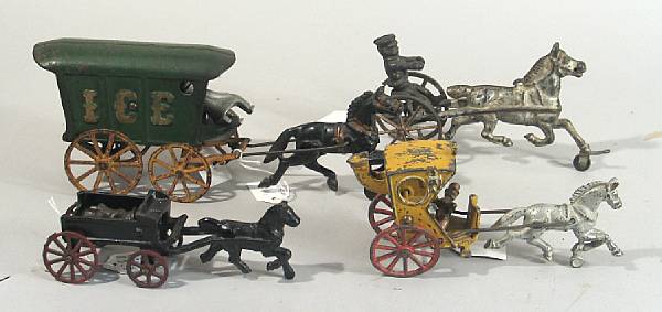 Appraisal: Horse drawn carts Lot of cast iron horse carts including