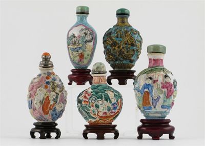 Appraisal: Five Chinese porcelain snuff bottle stoppers and stands moulded in