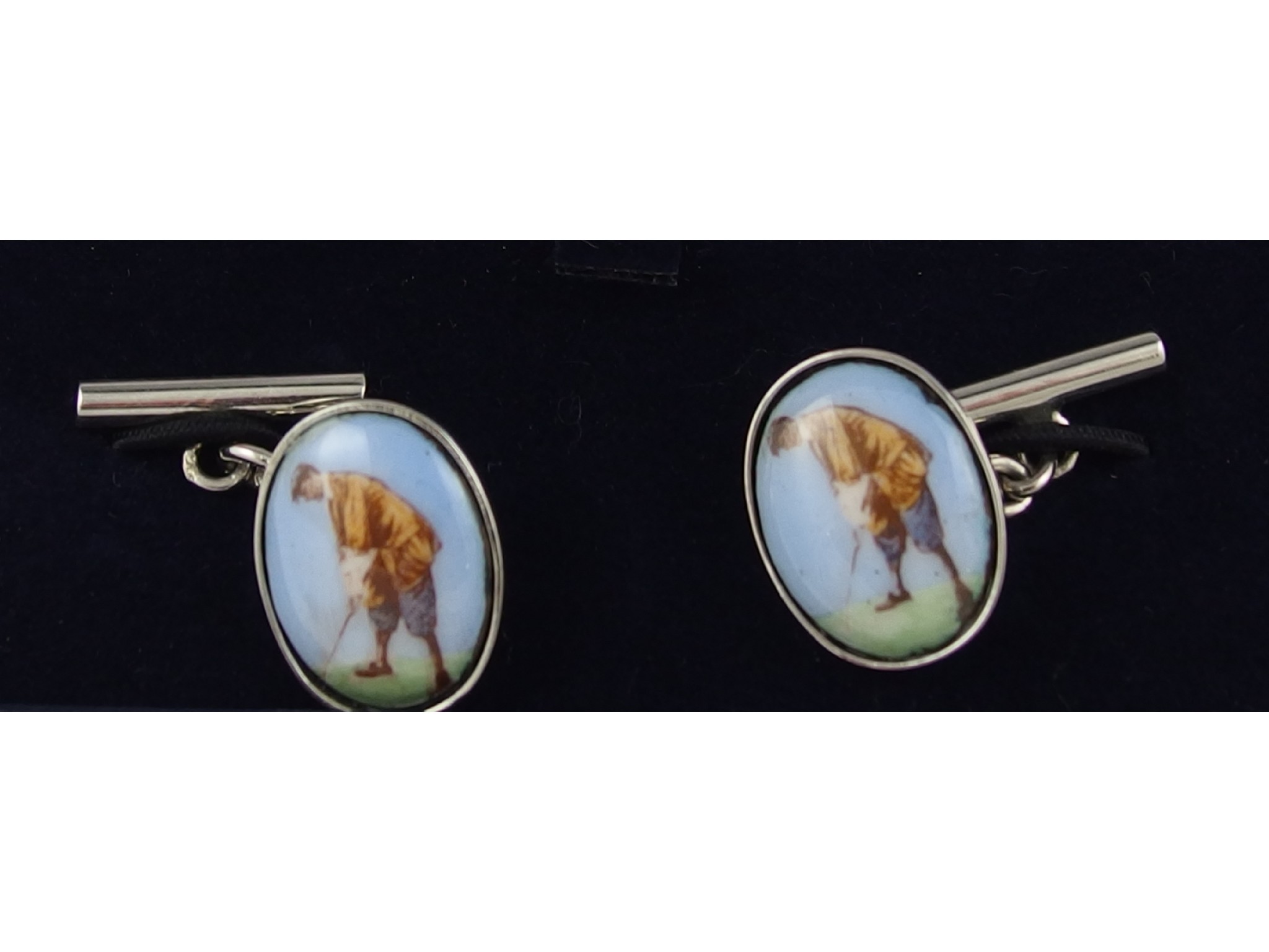 Appraisal: A pair of silver cufflinks with golfing theme