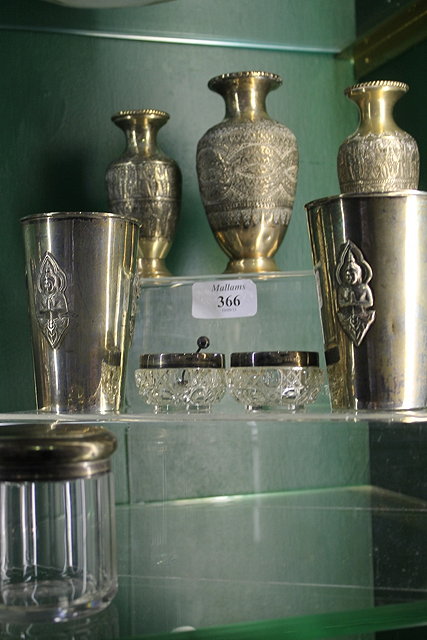 Appraisal: TWO BURMESE SILVER BEAKERS two silver candlesticks three silver metal