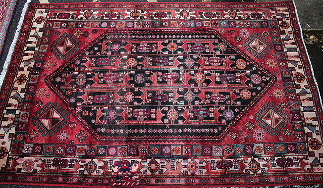 Appraisal: A BALUCHI BLACK GROUND RUG central diamond motif with stylised