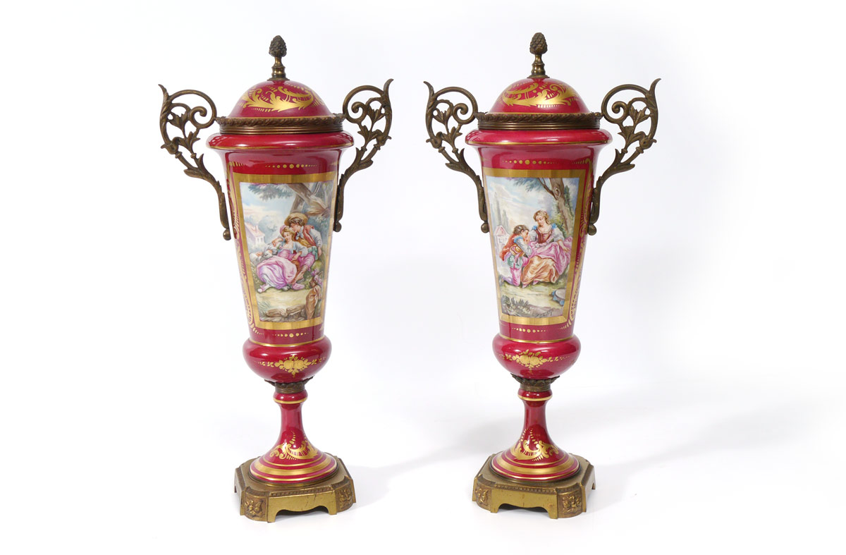 Appraisal: PAIR OF DECORATIVE SEVRES TYPE RED PORCELAIN URNS Metal mounted