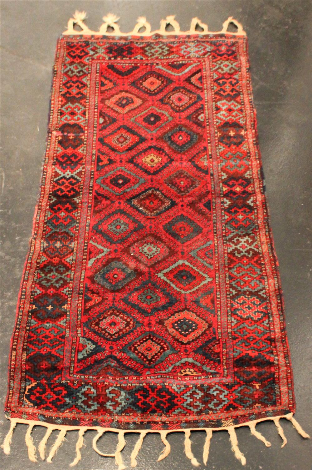 Appraisal: TWO TRIBAL RUGS the first a diamond pattern in reds