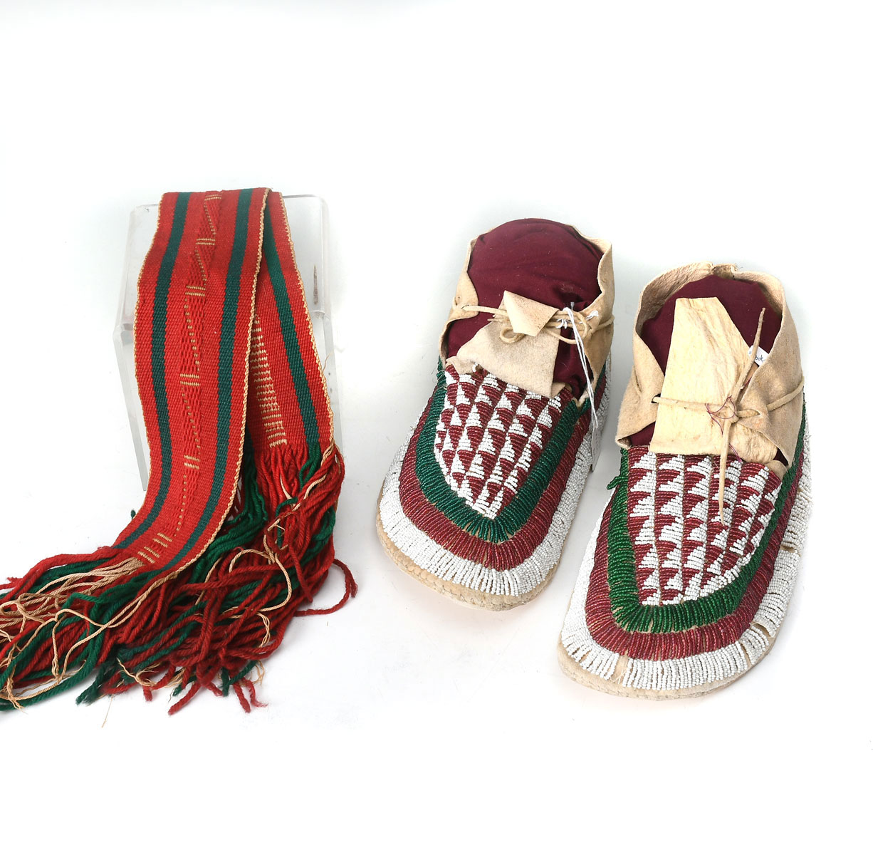 Appraisal: NATIVE AMERICAN ARAPAHO BEADED MOCCASINS NAVAJO SASH Arapaho men's moccasins