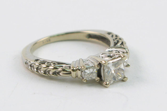 Appraisal: DIAMOND AND FOURTEEN KARAT WHITE GOLD RING centering a princess-cut