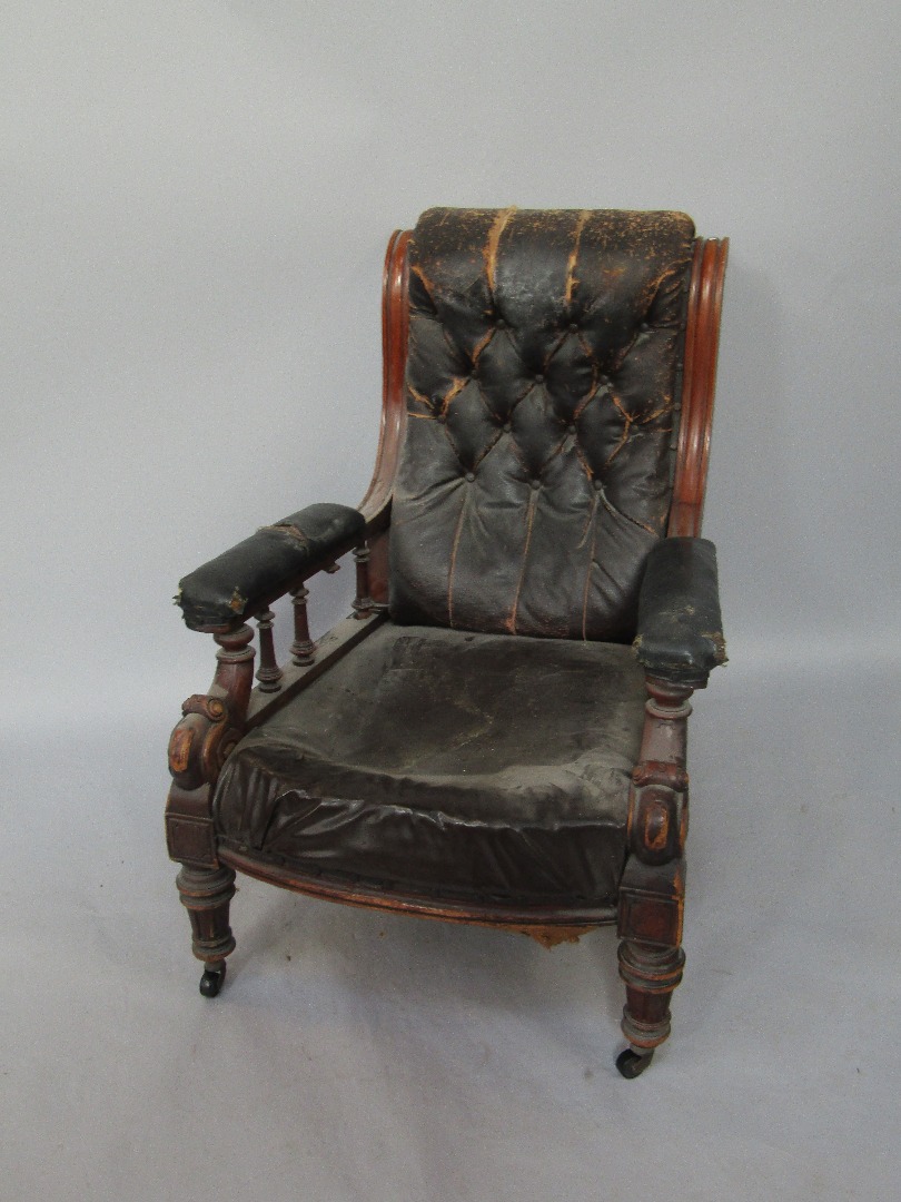 Appraisal: A Victorian mahogany gentleman's armchair with leather button back and