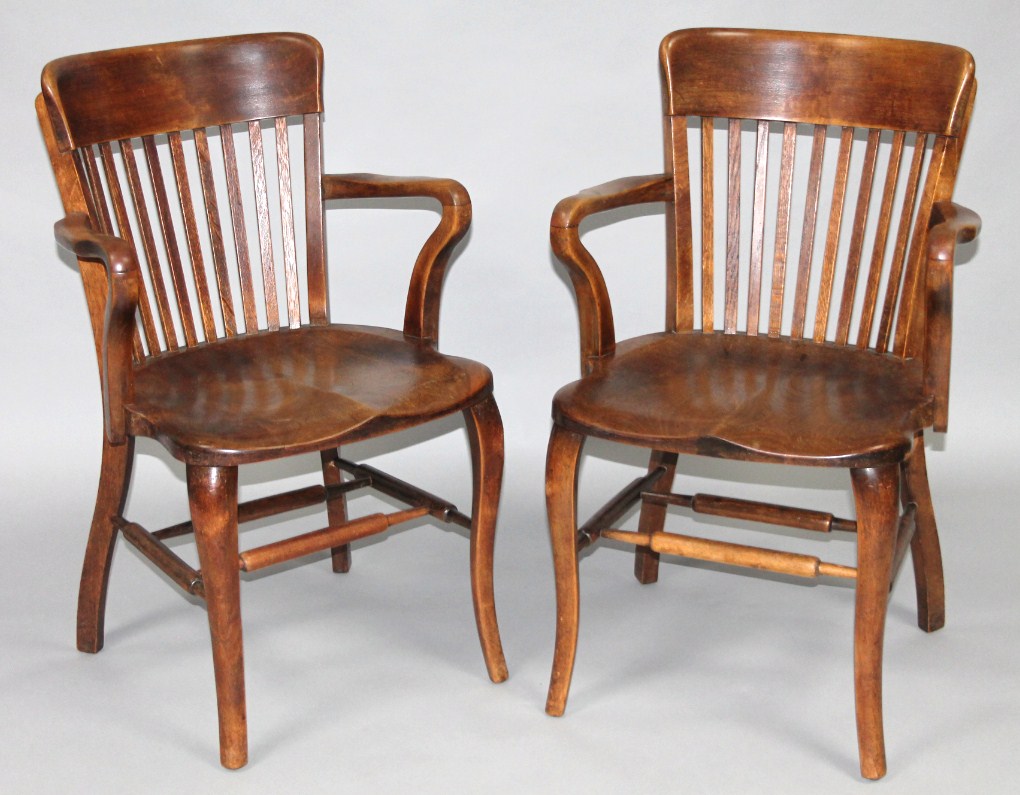 Appraisal: A pair of 's elm office style chairs with shaped