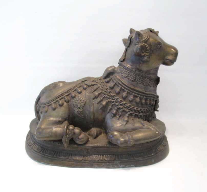 Appraisal: INDIAN BRASS COW SCULPTURE the seated cow in ceremonial dress