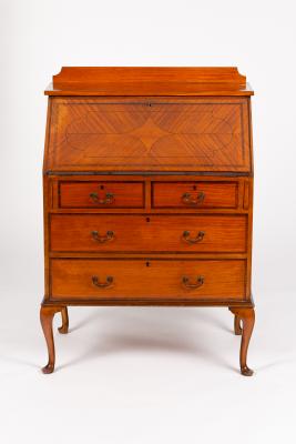 Appraisal: An Edwardian satinwood bureau crossbanded and fitted two long and