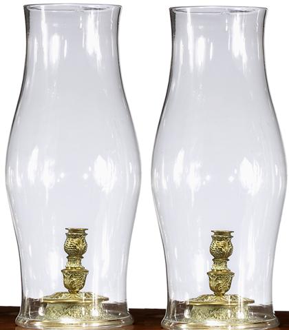 Appraisal: Pair of Continental brass candlesticks with blown glass hurricane shades