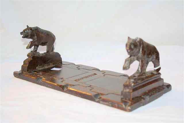 Appraisal: A BLACK FOREST CARVED WOODEN EXTENDING BOOK RACK with bear