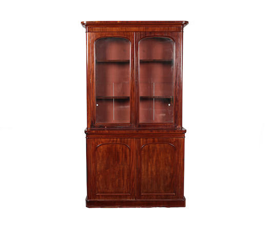 Appraisal: A Victorian mahogany bookcase The projecting cornice above a pair