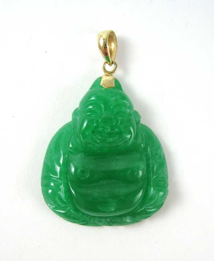 Appraisal: JADE AND FOURTEEN KARAT GOLD PENDANT with a carved green