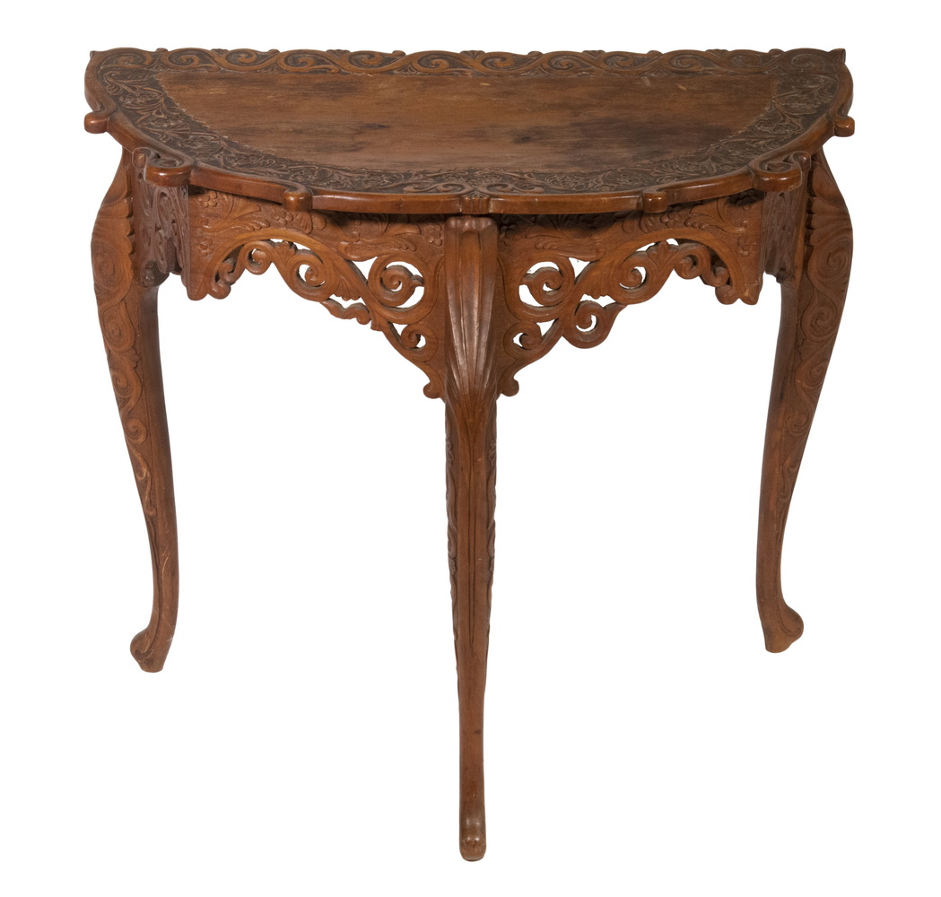 Appraisal: BRITISH COLONIAL INDIAN DEMILUNE CARVED SANDALWOOD TABLE Delicately carved with