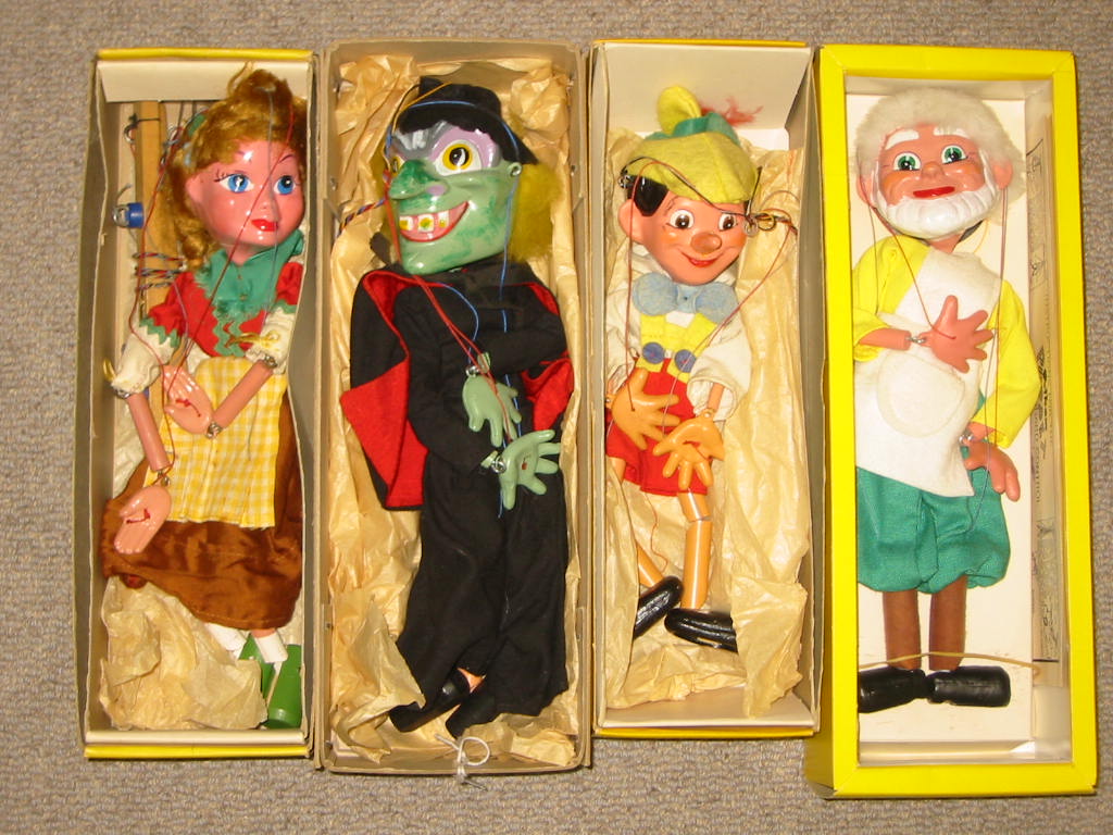 Appraisal: Four Pelham puppets SL Pinocchio yellow box SL Gepetto yellow