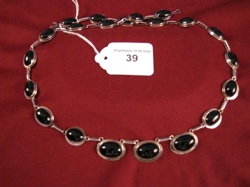 Appraisal: A black Onyx Necklace the graduated cabochon stone collet-set in